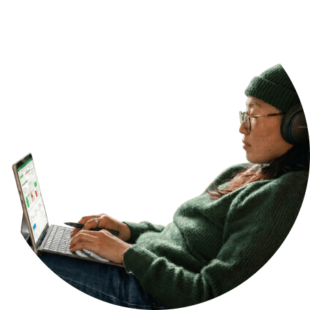 Software developer wearing headphones focused on laptop